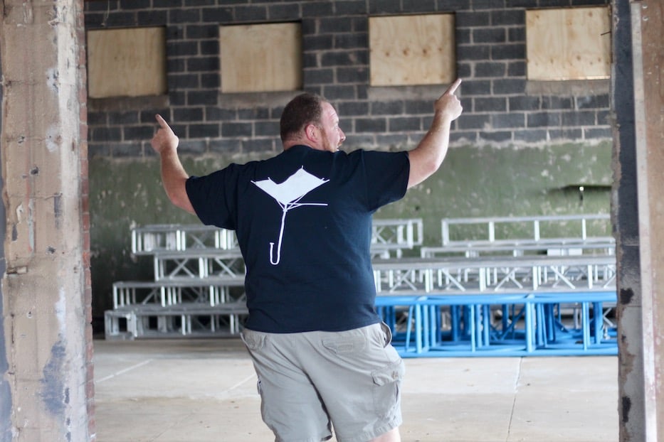 Ian Alderman gesturing in the future black box theater space at 280 Blake Street